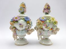 Pair of Sitzendorf vases and covers decorated with applied flowers and cherubs H26cm