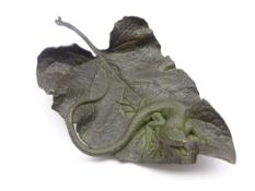 Bronze of a lizard on a leaf,