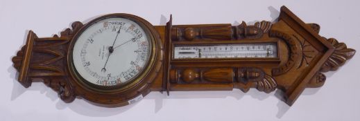 Early 20th century carved oak cased aneroid barometer with mercury thermometer, signed 'John Dyson,