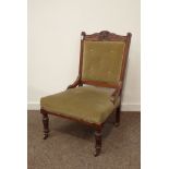 Edwardian walnut nursing chair, floral carved cresting rail, upholstered in green velvet,