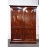 George IV mahogany wardrobe, projecting cornice above double fielded panelled doors,