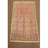 Persian Qom rug, scrolled interlaced foliate on beige and red linear fields, guarded border,