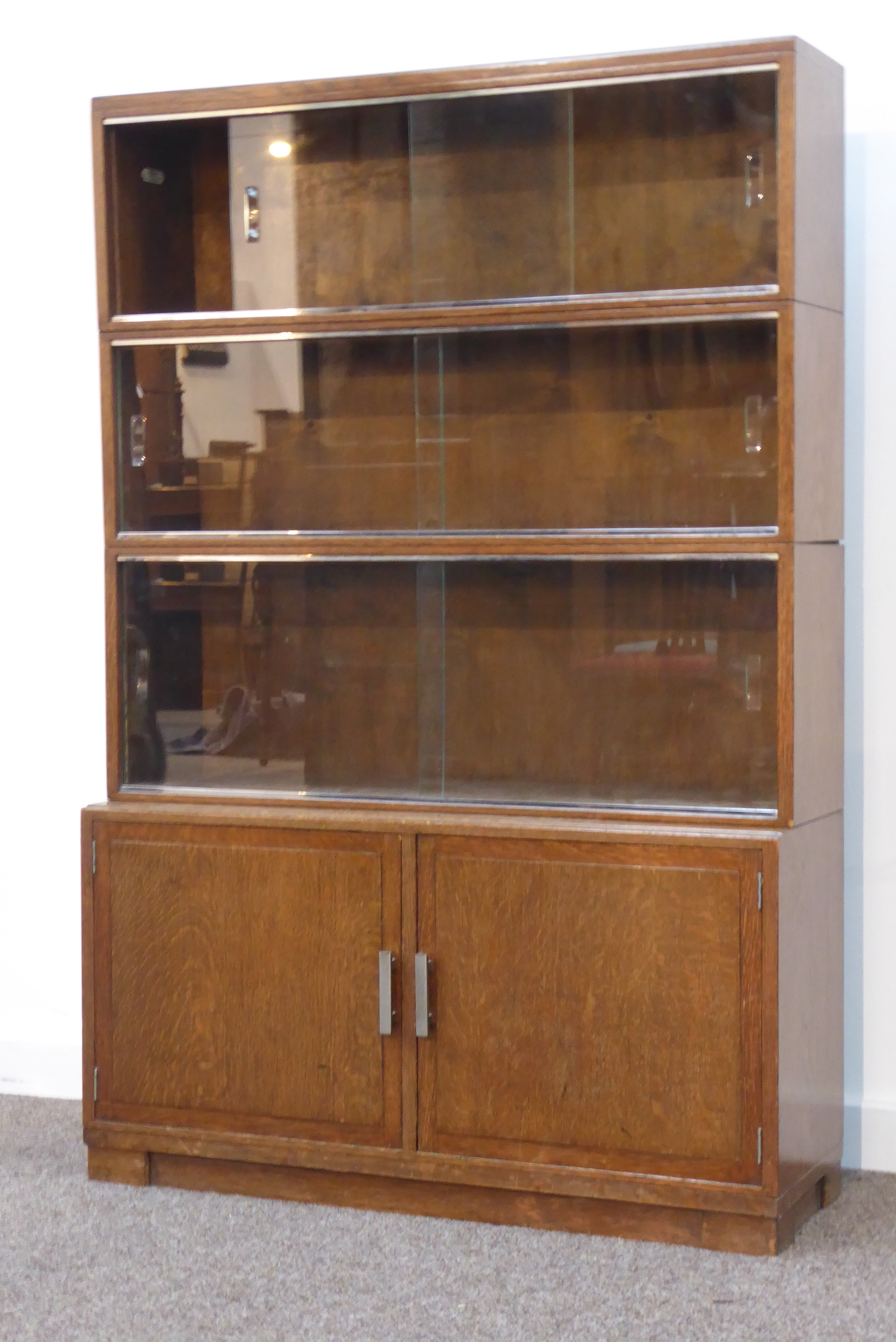 Early 20th century oak Minty stacking bookcase on cupboard,