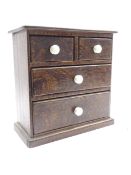 Small Victorian stained pine chest fitted with two short and two long drawers with ceramic handles