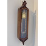 Small mid 19th Century wall clock in a walnut case, with carved pediment and apron,