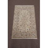 Persian Kashan beige ground rug, central medallion on beige field with interlaced scrolling foliate,