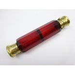 Victorian ruby glass double ended scent flask of panel sided design with engraved gilt metal mounts