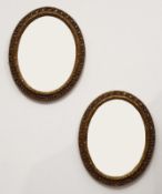 Pair 20th century gilt framed oval mirrors,