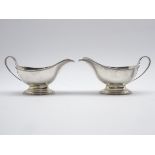 Pair of silver sauce boate with reeded handles and a short pedestal foot L17cm London 1933 Maker