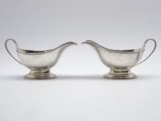 Pair of silver sauce boate with reeded handles and a short pedestal foot L17cm London 1933 Maker