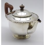Silver circular teapot with crimped rim,