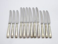 Set of 6 silver handled shell pattern table knives and 6 matching dessert knives Sheffield 1975