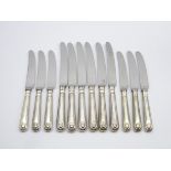 Set of 6 silver handled shell pattern table knives and 6 matching dessert knives Sheffield 1975