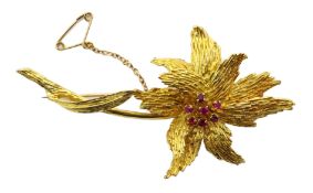 18ct gold flower stem brooch, the central disk set with seven rubies, makers mark deM,