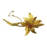 18ct gold flower stem brooch, the central disk set with seven rubies, makers mark deM,