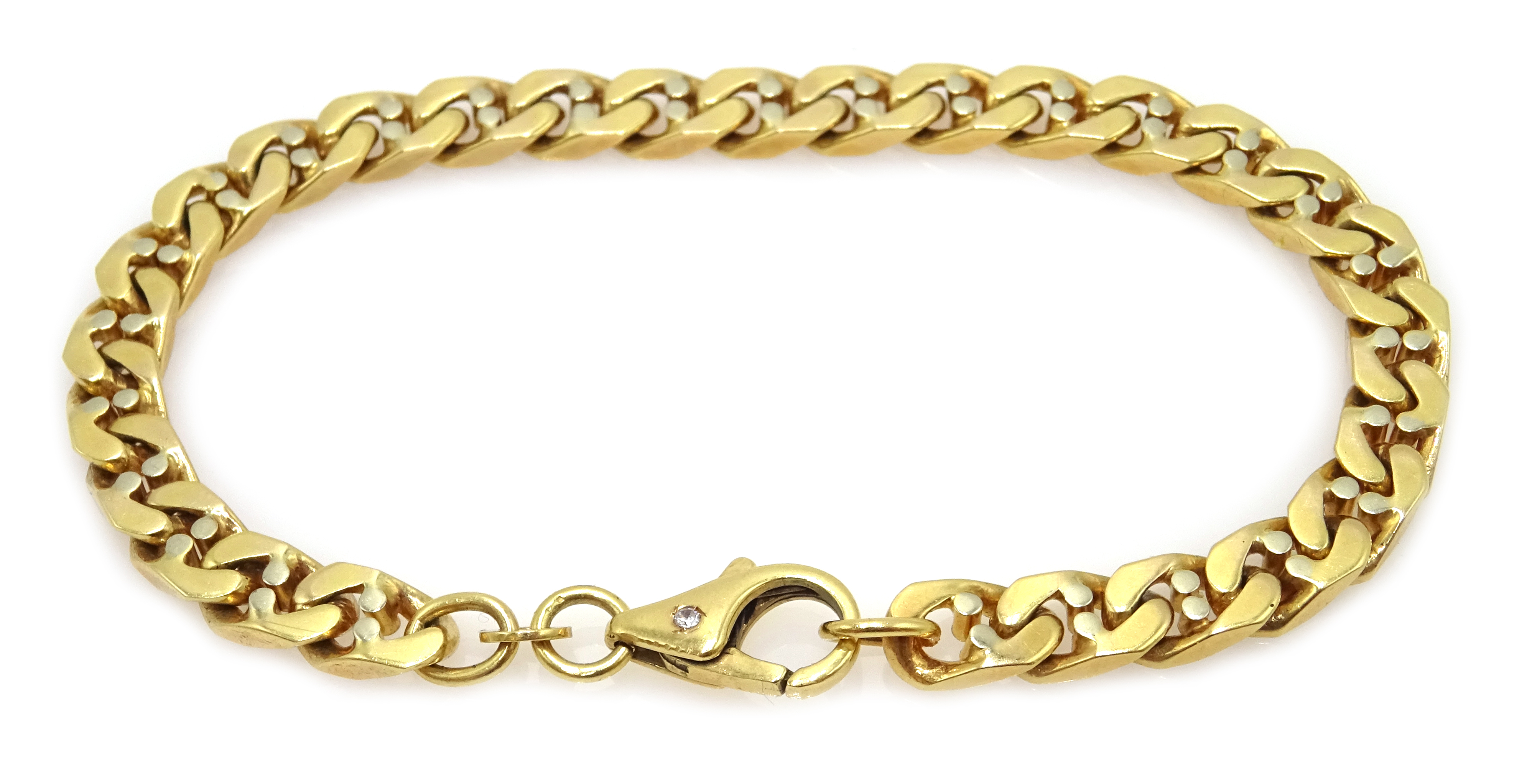 Gold flattened curb bracelet, the clasp set with a single stone,