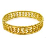 Ethiopian 22ct gold (tested) filigree design bangle with screw clasp, approx 33.