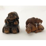 Two Signed Wood Netsuke carved with immortal and oxen and goat