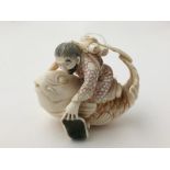 Ivory Okimono carved and stained traveller riding an oversized fish