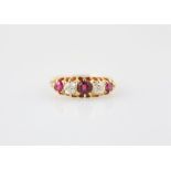 18ct Five Stone Ruby & Diamond Bridge Ring central round mixed cut ruby with ruby and synthetic