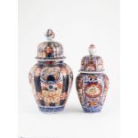 Two Graduated Size Imari Vase and Covers ovoid bodies painted in traditional manner 31cm and 26cm