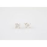 Pair 14ct White Gold Solitaire Diamond Stud Earrings each of four claw set round modern brilliant
