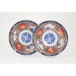 Pair C19th Imari Plates slight curved rim and foot with traditional panel decorations. under glaze