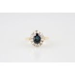 18ct 13stone Sapphire & Diamond Cluster Ring central oval mixed cut medium blue sapphire with