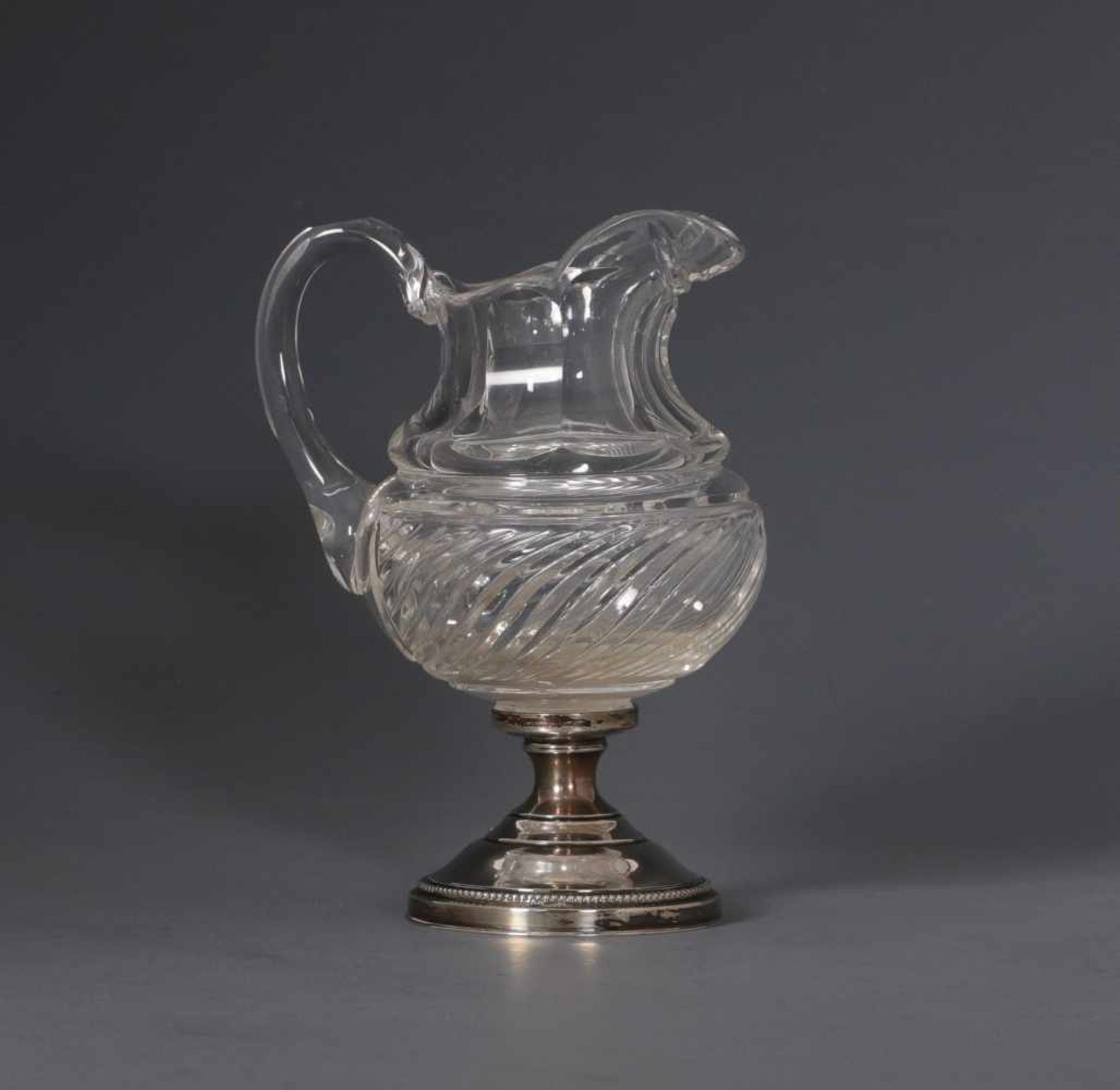 A crystal cream jug with silver foot, circa 1900A crystal cream jug with silver foot, circa