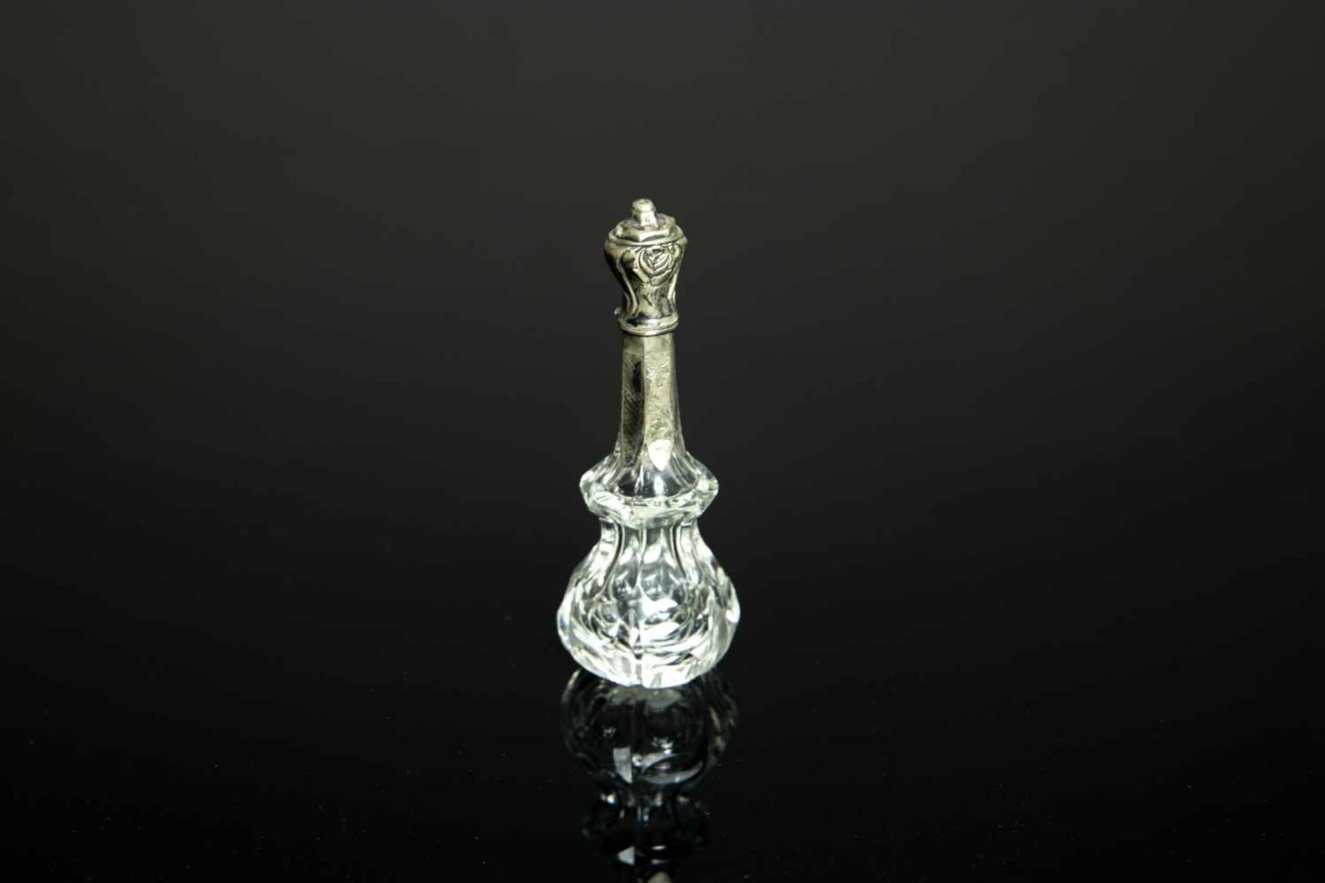 A crystal perfume bottle with silver capA crystal perfume bottle with silver capH. 11 cm