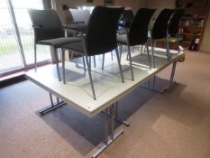 Four white laminate ractangular tables and eight grey cloth upholstered chairs