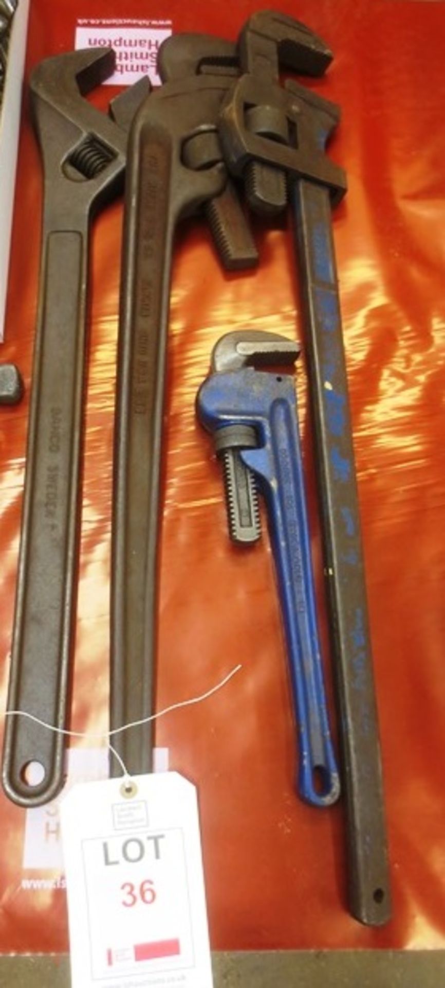 Four assorted adjustable wrenches