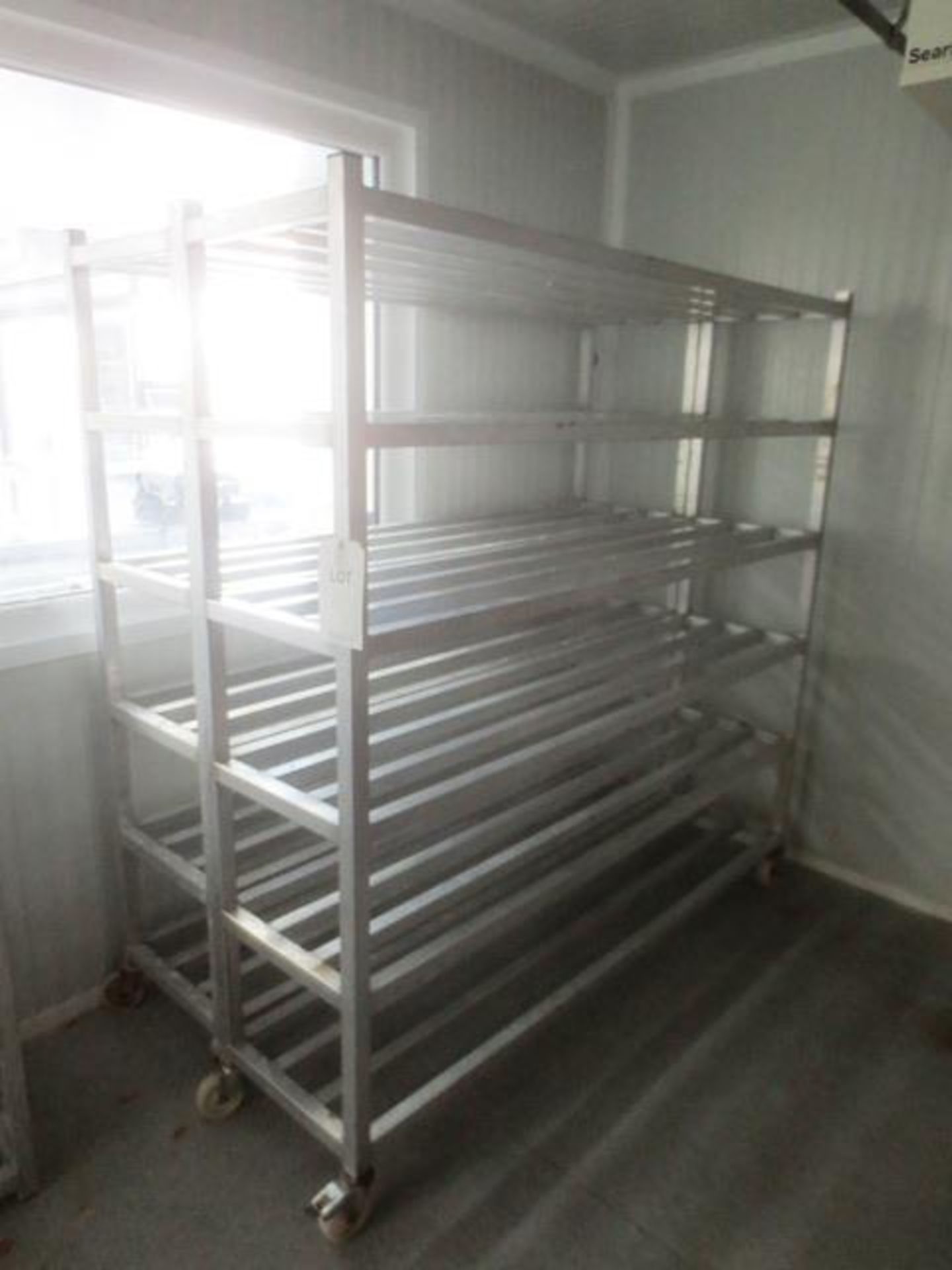 Two stainless steel mobile storage racks, approx 1800 x 450mm