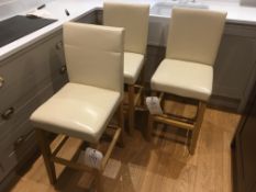 Three wood framed cream leather upholstered bar stools