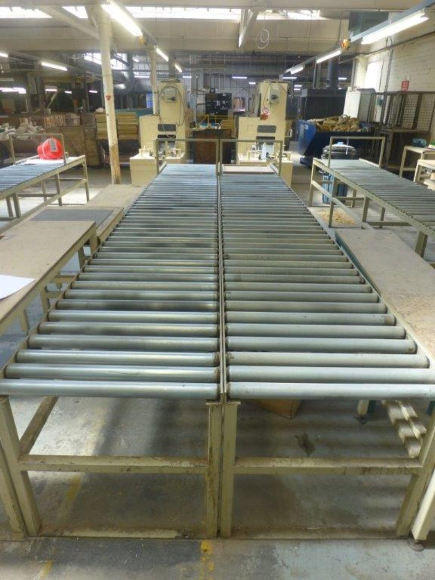 2 sections 4.8m x 700mm gravity fed roller conveyor and 3 assorted steel framed tables
