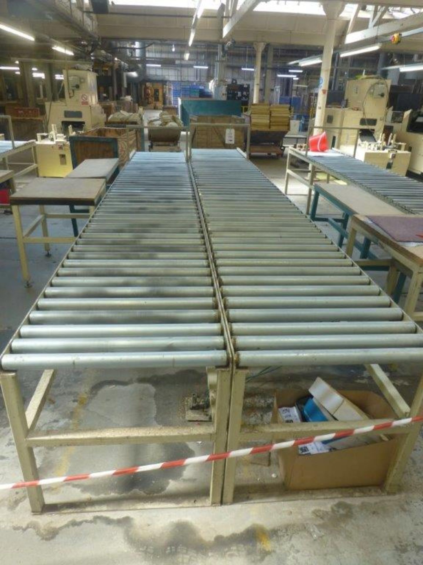 2 sections 4.8m x 700mm gravity fed roller conveyor and 2 assorted steel framed tables