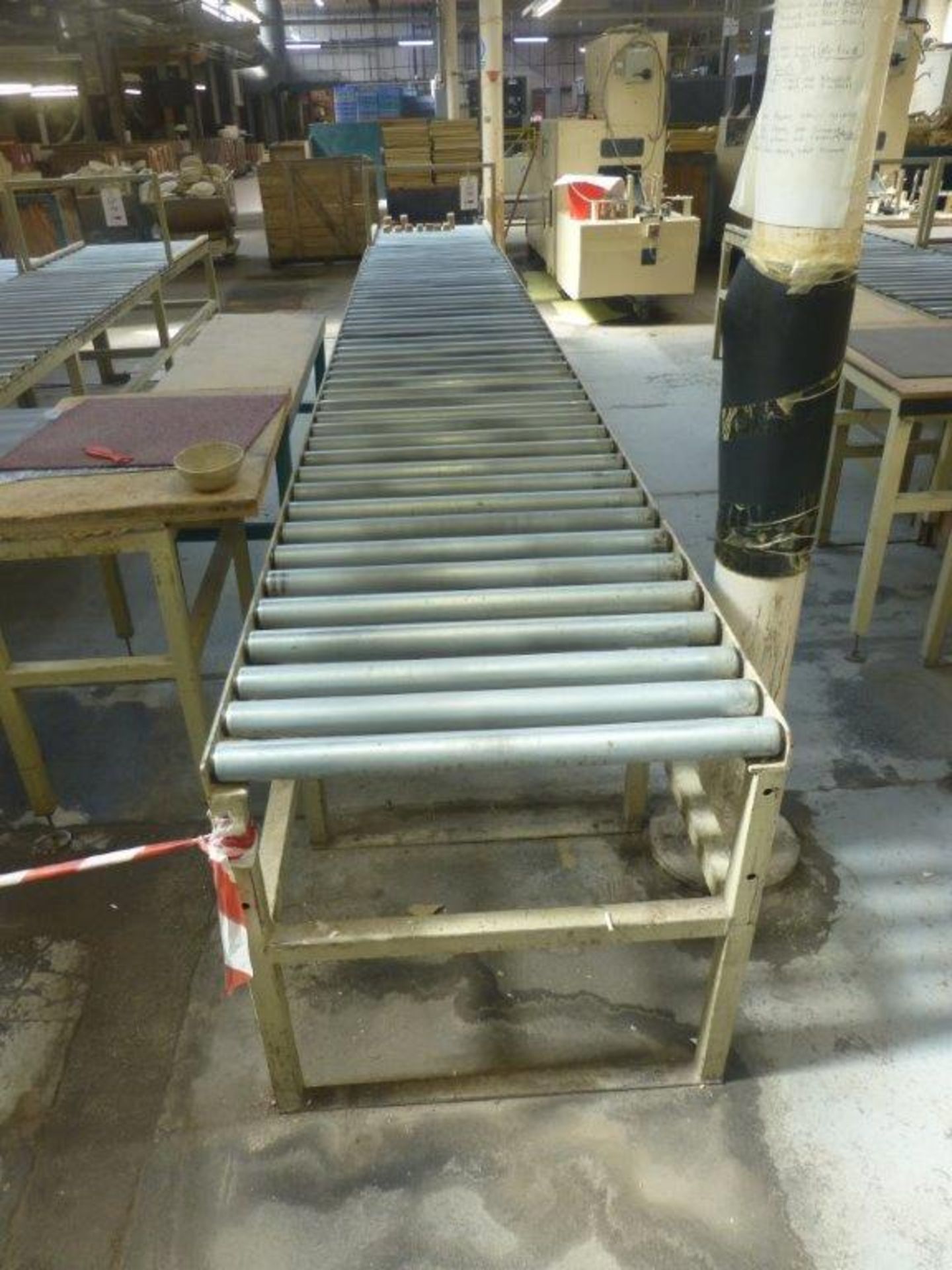 2 sections 5.4m x 700mm gravity fed roller conveyor and 3 assorted steel framed tables