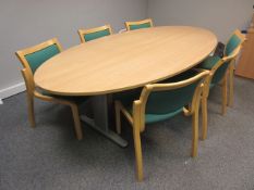 Light oak oval table, 6 green tweed stand chairs, flip chart and low light oak 2-door cupboard