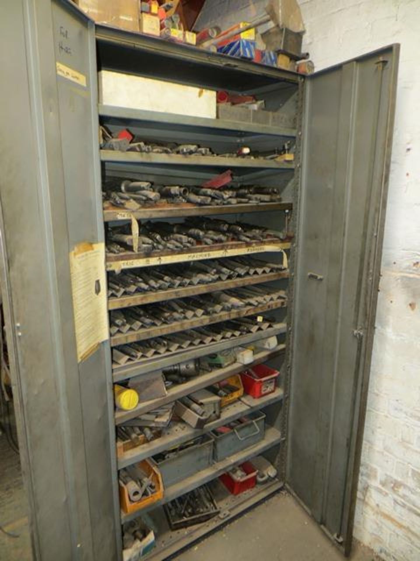 Two door steel cupboard and contents to include various drilling & milling cutters as lotted