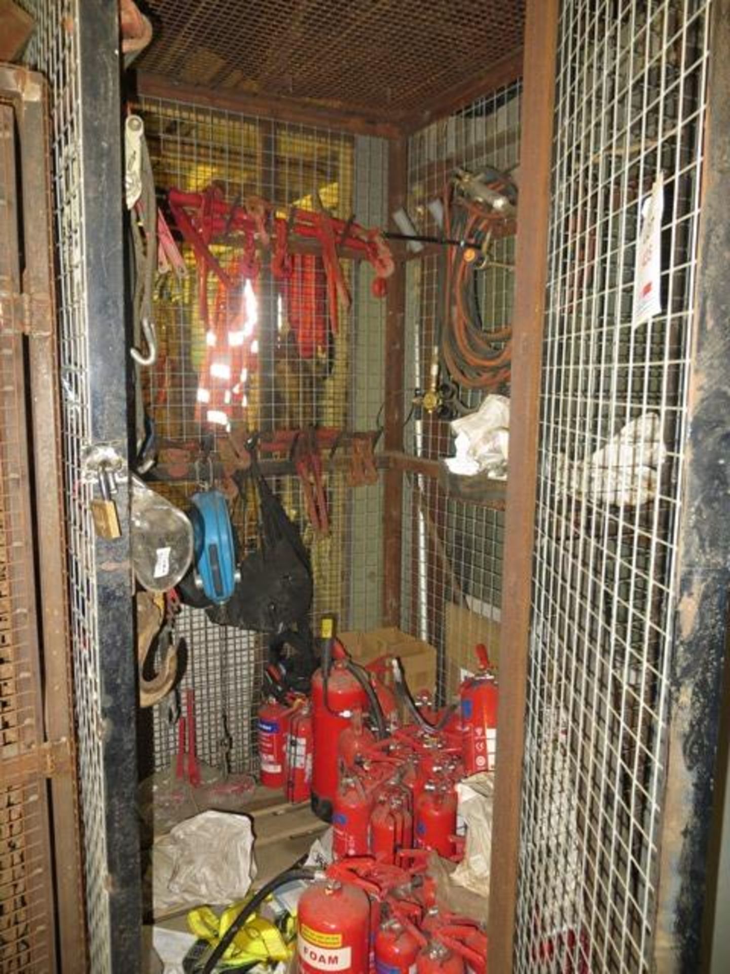 Contents of cage to include cutting torch with gauges, various chain tensioning ratchet straps, fall