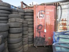 Brown steel shipping container, 40 ft. x 8 ft. approx. plus rack and contents including steering