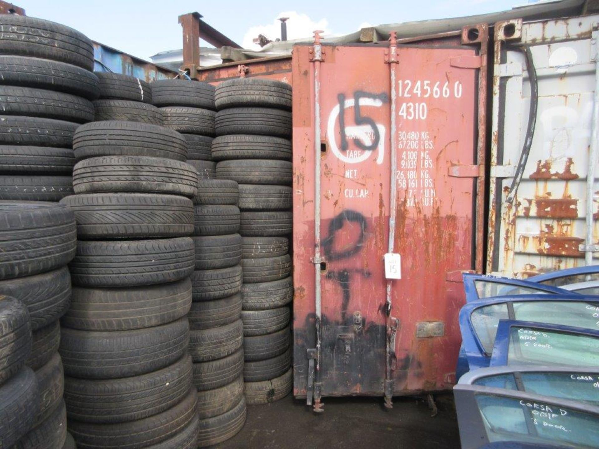 Brown steel shipping container, 40 ft. x 8 ft. approx. plus rack and contents including steering