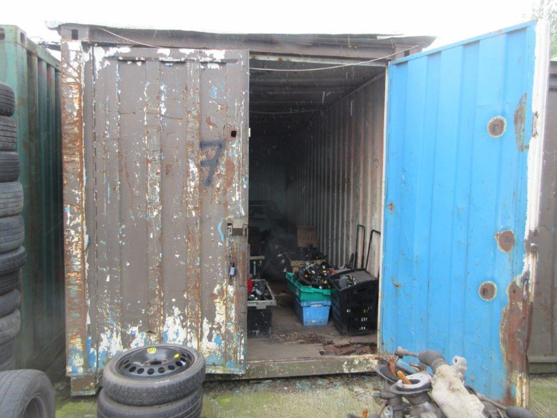 Brown/white/blue steel shipping container, 20 ft. x 8 ft. approx. plus rack and contents including