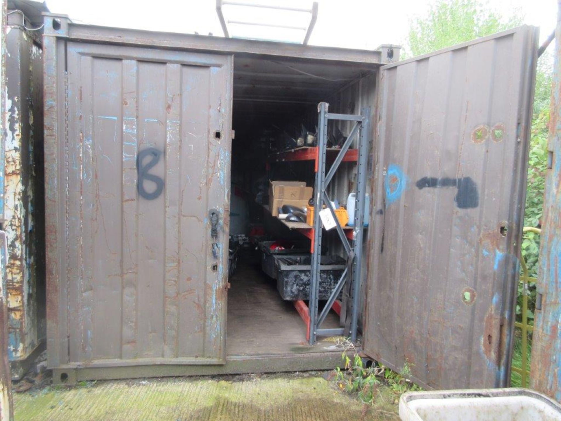 Brown steel shipping container, 20 ft. x 8 ft. approx. plus rack and contents including electric