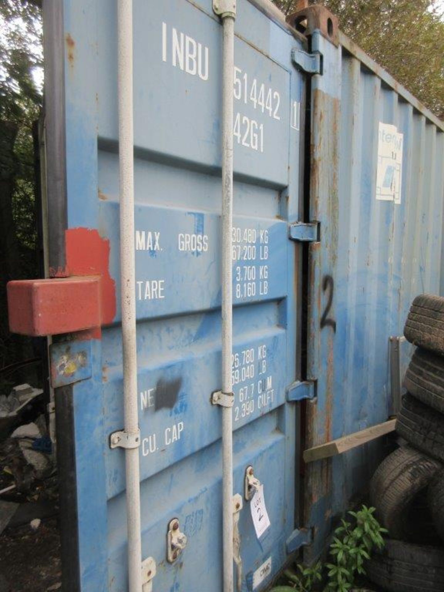 Blue steel shipping container, 40 ft. x 8 ft. approx. plus rack and contents including dismantled
