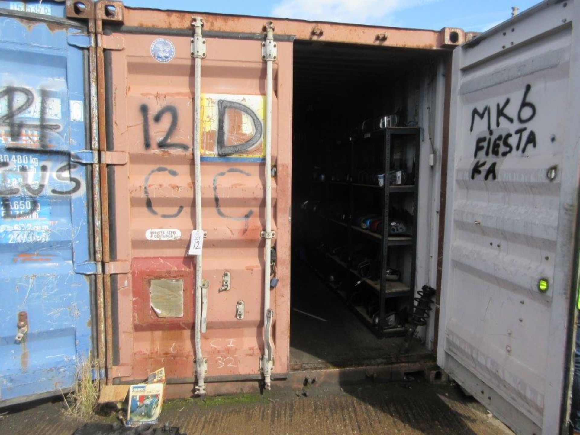 Brown steel shipping container, 40 ft. x 8 ft. approx. plus rack and contents of mainly Ford