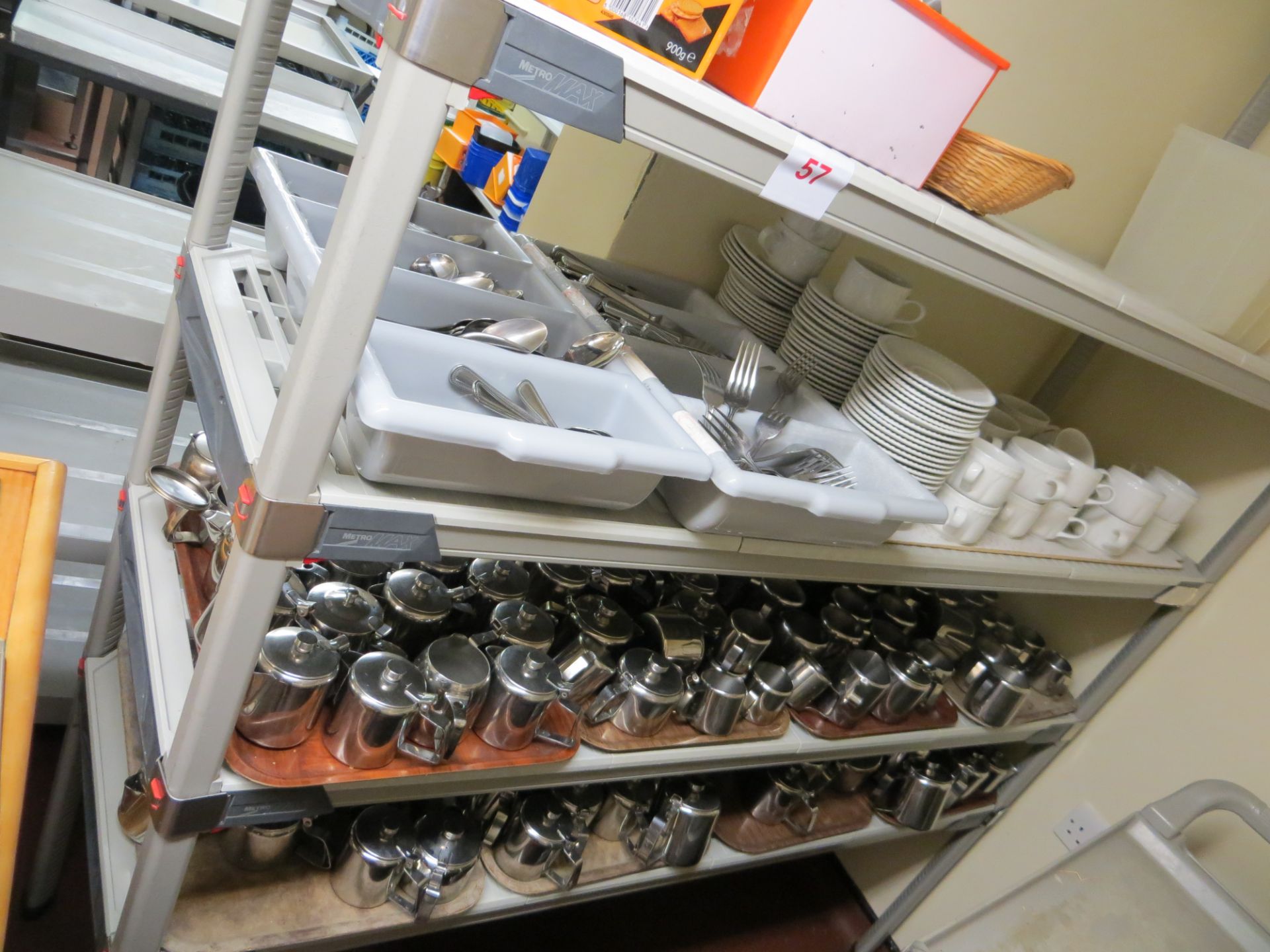 4 tier catering unit and contents to include cutlery, teacups & saucers, stainless steel tea