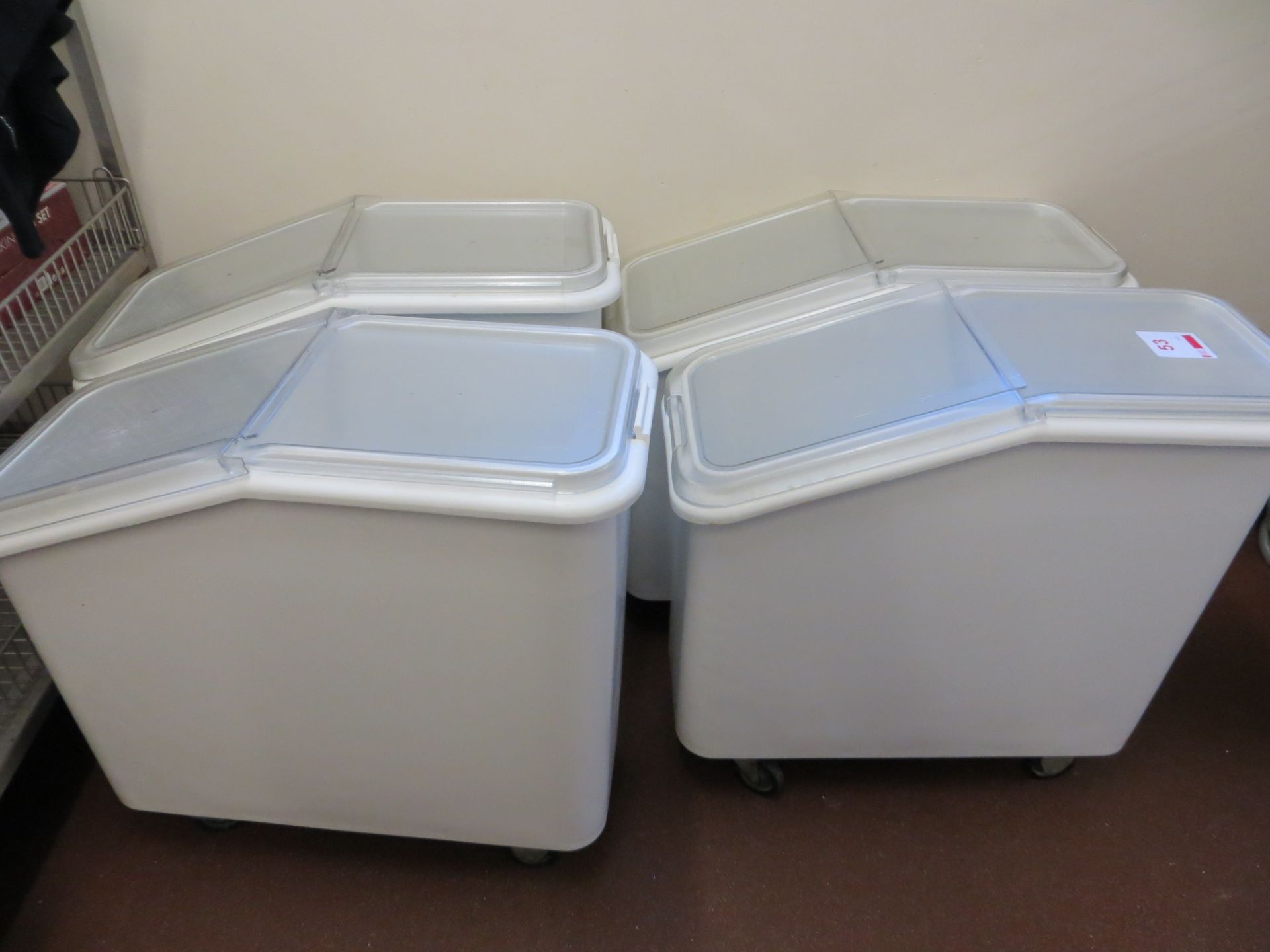 Four mobile plastic dry food storage bins