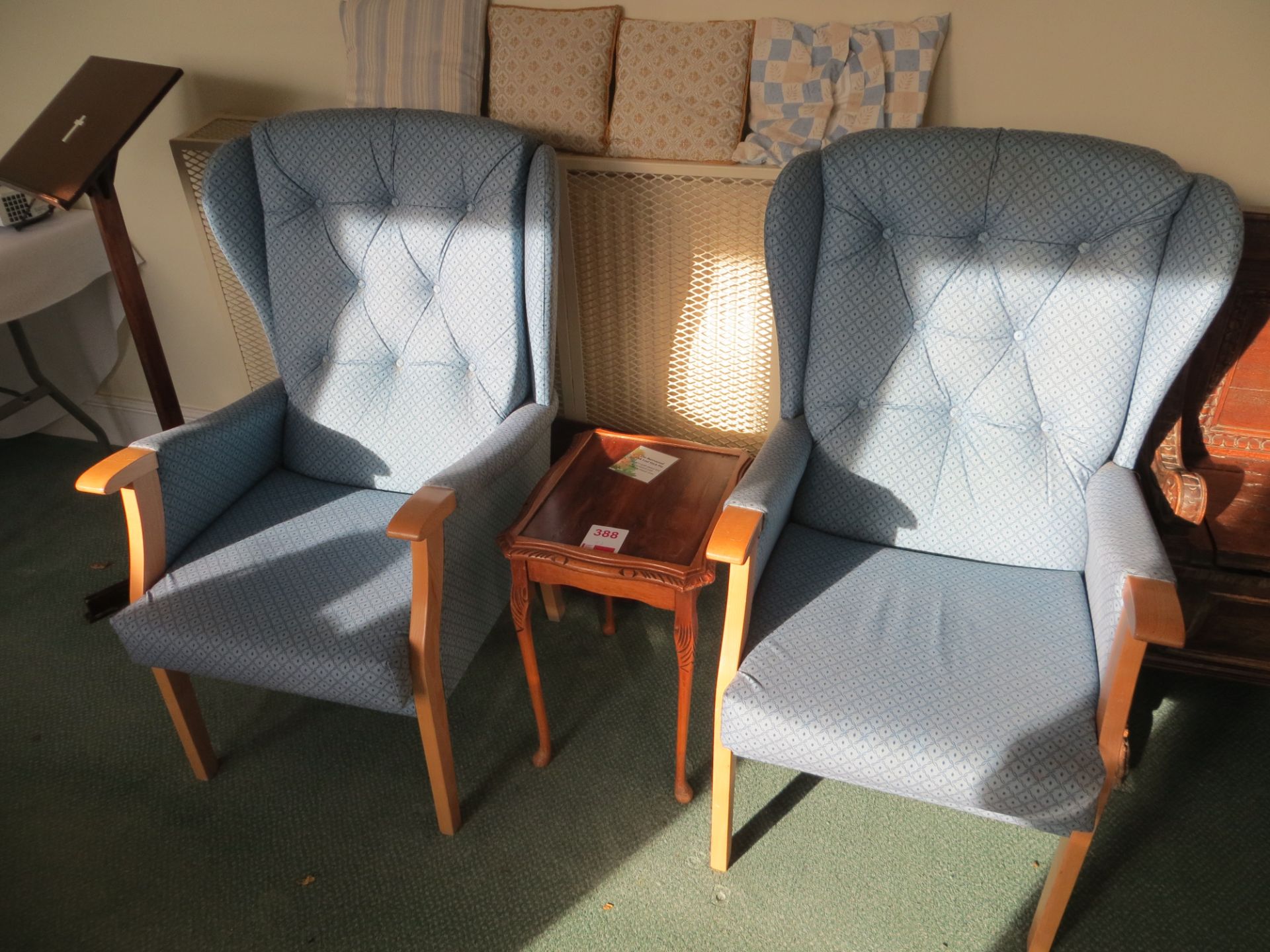 Two blue cloth high back arm chairs c/w with small wooden lamp table