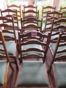 Four matching green cloth dining chairs